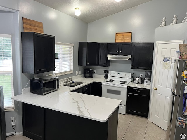 6433 S Laurel Canyon Dr W, Salt Lake City, UT 84118 - kitchen featuring appliances with stainless steel finishes, under cabinet range hood, dark cabinets, a peninsula, and a textured ceiling