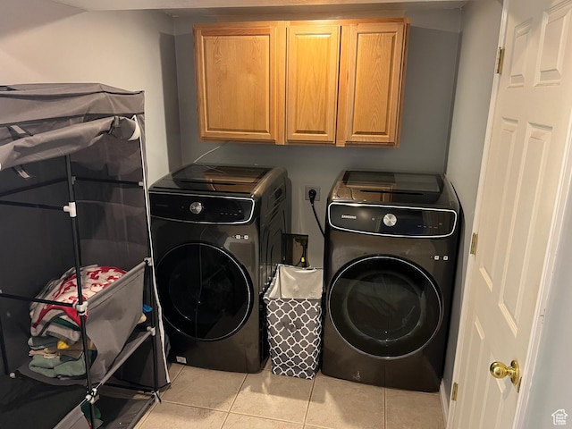 6433 S Laurel Canyon Dr W, Salt Lake City, UT 84118 - laundry room with cabinet space, light tile patterned floors, and washer and clothes dryer
