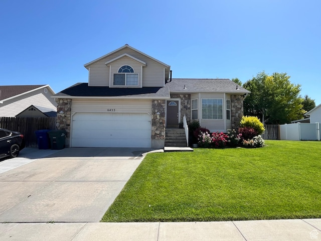 6433 S Laurel Canyon Dr W, Salt Lake City, UT 84118 - view of front of property with stone siding, driveway, and a garage