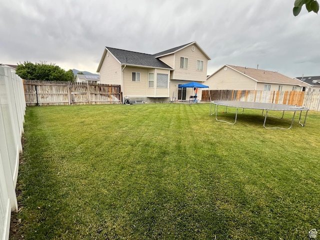 6433 S Laurel Canyon Dr W, Salt Lake City, UT 84118 - back of property with a trampoline and a fenced backyard