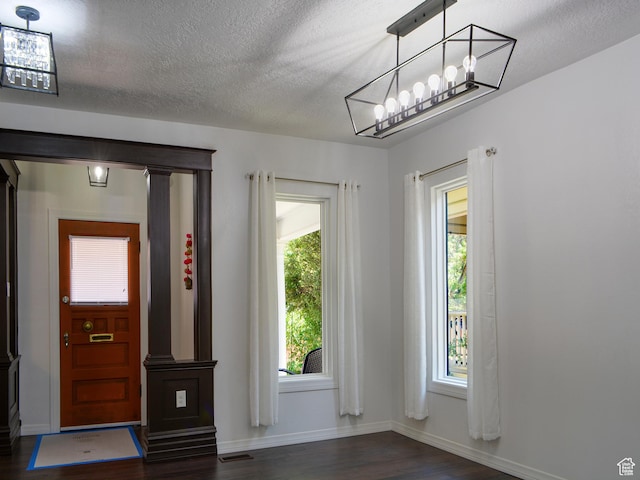 374 E 6th Ave, Salt Lake City, UT 84103 - entryway featuring dark wood-style floors, healthy amount of natural light, a textured ceiling, and a chandelier