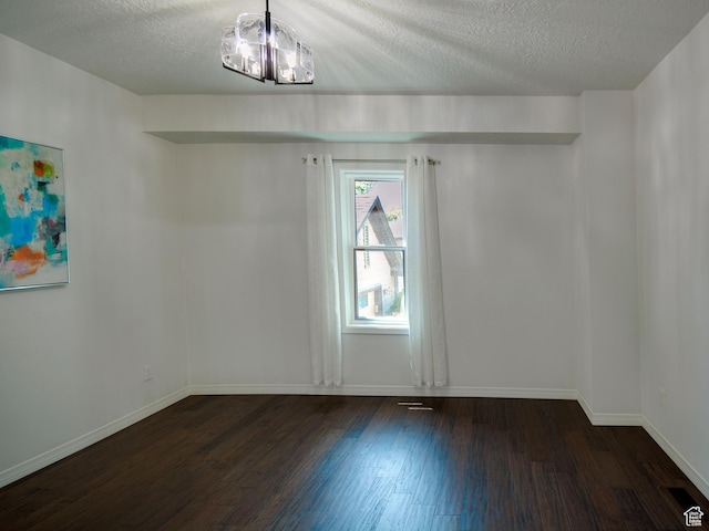 374 E 6th Ave, Salt Lake City, UT 84103 - empty room featuring dark wood-style floors, a textured ceiling, and a chandelier