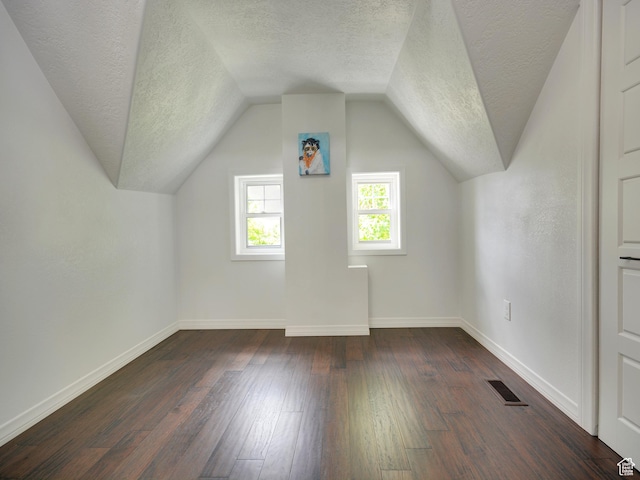 374 E 6th Ave, Salt Lake City, UT 84103 - additional living space with a textured ceiling, dark wood-type flooring, and vaulted ceiling
