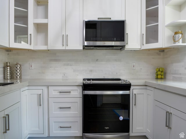 374 E 6th Ave, Salt Lake City, UT 84103 - kitchen with appliances with stainless steel finishes, open shelves, white cabinets, backsplash, and glass insert cabinets
