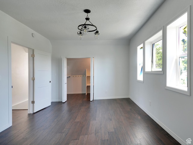 374 E 6th Ave, Salt Lake City, UT 84103 - empty room featuring dark wood-style flooring, a chandelier, and a textured ceiling
