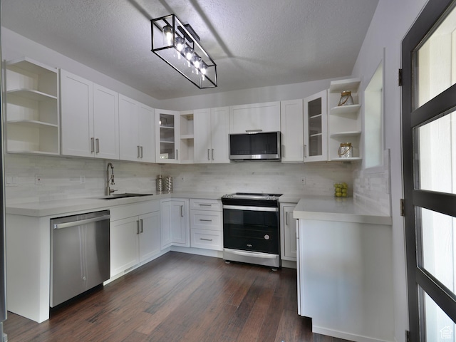 374 E 6th Ave, Salt Lake City, UT 84103 - kitchen with open shelves, appliances with stainless steel finishes, light countertops, dark wood finished floors, and tasteful backsplash