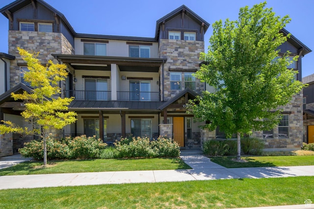 10465 S Beetdigger Blvd, Sandy, UT 84070 - craftsman-style home featuring stone siding, a balcony, stucco siding, and a front lawn