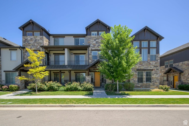 10465 S Beetdigger Blvd, Sandy, UT 84070 - craftsman-style home featuring stone siding, stucco siding, a balcony, and a front yard