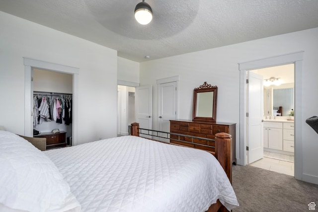 10465 S Beetdigger Blvd, Sandy, UT 84070 - bedroom featuring light colored carpet, ensuite bathroom, and a textured ceiling