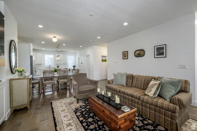 10465 S Beetdigger Blvd, Sandy, UT 84070 - living room featuring dark wood-type flooring, recessed lighting, and a textured ceiling
