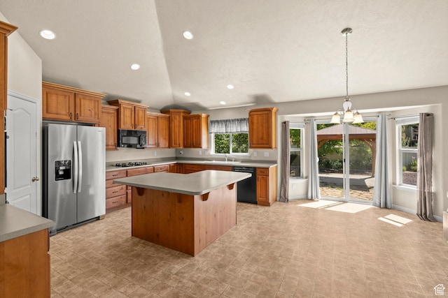 1221 S 130th St E, Payson, UT 84651 - kitchen with black appliances, vaulted ceiling, a kitchen island, brown cabinets, and a chandelier