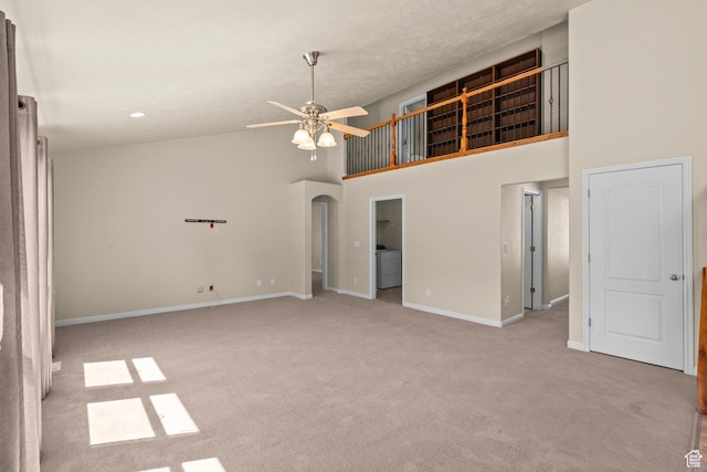 1221 S 130th St E, Payson, UT 84651 - carpeted spare room featuring a towering ceiling, a ceiling fan, washer / dryer, and arched walkways