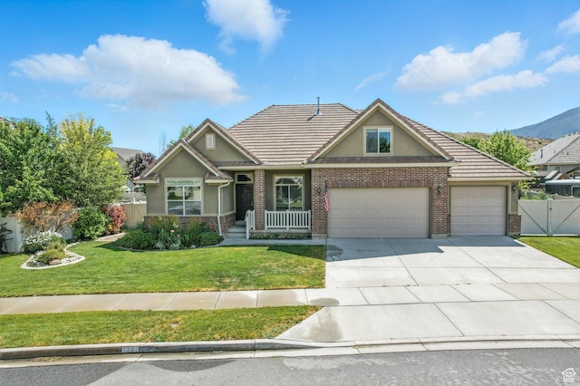 1221 S 130th St E, Payson, UT 84651 - view of front of house featuring an attached garage, stucco siding, concrete driveway, a tiled roof, and brick siding