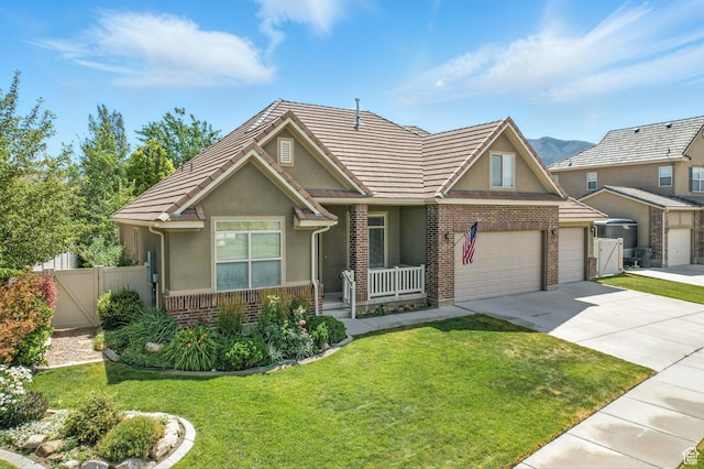 1221 S 130th St E, Payson, UT 84651 - view of front of home featuring brick siding, covered porch, driveway, stucco siding, and a garage