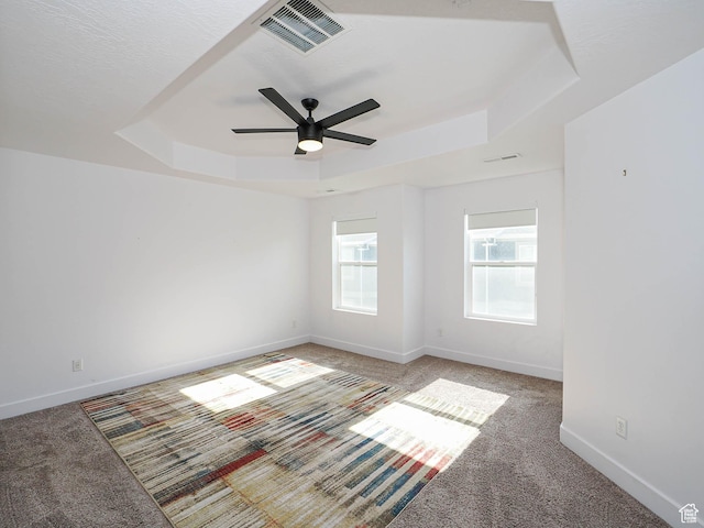 1792 W Dalmeny Way, Riverton, UT 84065 - spare room with a tray ceiling, light colored carpet, and a ceiling fan