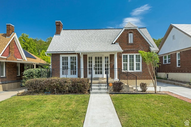 1381 E 1300 S, Salt Lake City, UT 84105 - tudor-style house featuring a front yard, a chimney, and brick siding