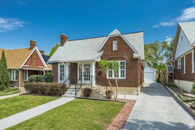 1381 E 1300 S, Salt Lake City, UT 84105 - tudor house with brick siding, an outbuilding, a front lawn, a shingled roof, and a chimney