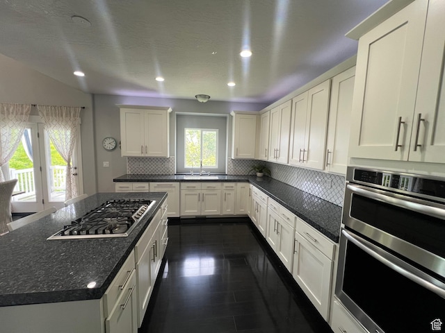 10337 S Wapati Moon Pl, South Jordan, UT 84095 - kitchen with appliances with stainless steel finishes, tasteful backsplash, recessed lighting, dark tile patterned flooring, and white cabinets