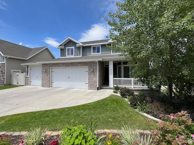 10337 S Wapati Moon Pl, South Jordan, UT 84095 - view of front of home with a porch, concrete driveway, roof with shingles, board and batten siding, and an attached garage