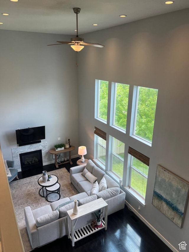 10337 S Wapati Moon Pl, South Jordan, UT 84095 - living room featuring plenty of natural light, wood finished floors, a fireplace with flush hearth, recessed lighting, and a ceiling fan