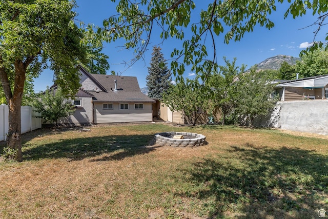 525 3rd St, Ogden, UT 84404 - fenced backyard featuring an outdoor fire pit and a mountain view