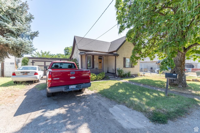 525 3rd St, Ogden, UT 84404 - bungalow-style home with a front yard, stucco siding, and a shingled roof