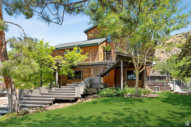 4307 Churchill Dr N Unit 97, Provo, UT 84604 - back of property featuring stairs, a wooden deck, a yard, and brick siding