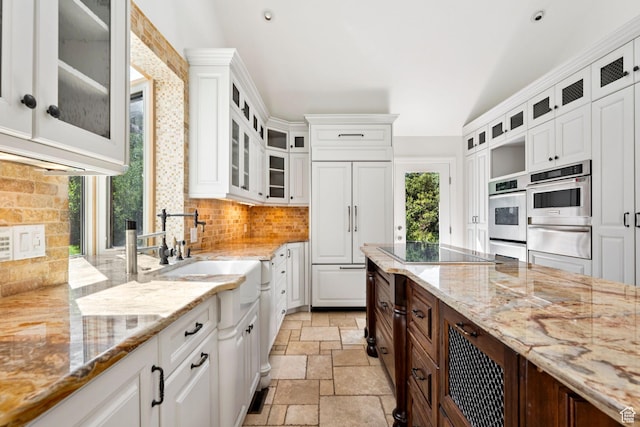 4307 Churchill Dr N Unit 97, Provo, UT 84604 - kitchen with a warming drawer, stone tile floors, tasteful backsplash, stainless steel double oven, and white cabinets