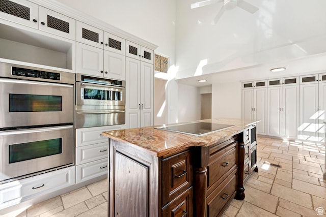 4307 Churchill Dr N Unit 97, Provo, UT 84604 - kitchen featuring stainless steel double oven, a warming drawer, electric cooktop, a high ceiling, and white cabinetry