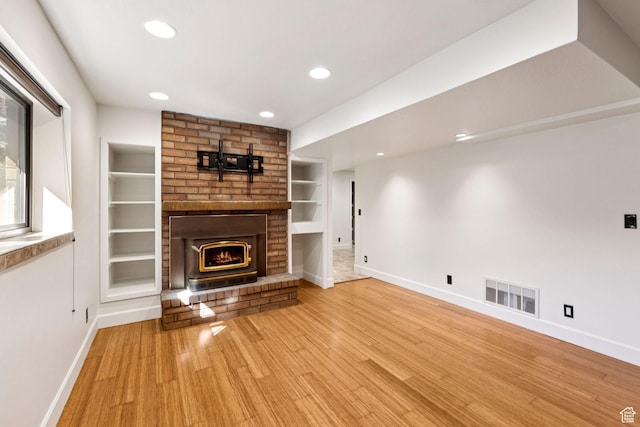4307 Churchill Dr N Unit 97, Provo, UT 84604 - unfurnished living room with recessed lighting, built in features, wood finished floors, and a brick fireplace