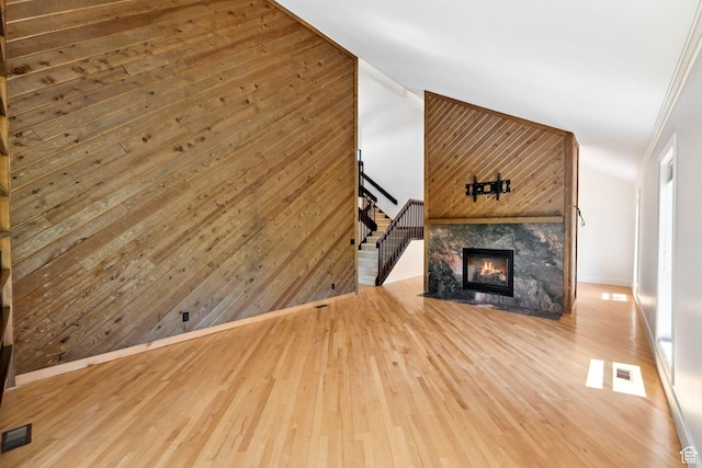 4307 Churchill Dr N Unit 97, Provo, UT 84604 - unfurnished living room with stairway, lofted ceiling, wood finished floors, and a glass covered fireplace
