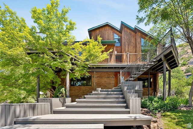 4307 Churchill Dr N Unit 97, Provo, UT 84604 - view of front of house featuring stairs, a wooden deck, and brick siding