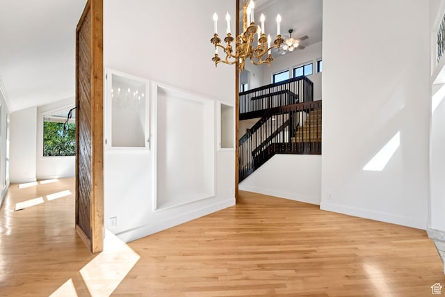 4307 Churchill Dr N Unit 97, Provo, UT 84604 - unfurnished dining area with a chandelier, wood finished floors, and a towering ceiling