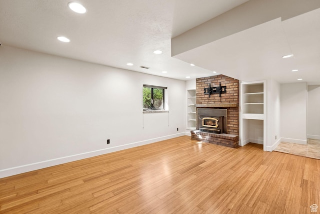 4307 Churchill Dr N Unit 97, Provo, UT 84604 - unfurnished living room with light wood-type flooring, recessed lighting, a fireplace, and built in shelves