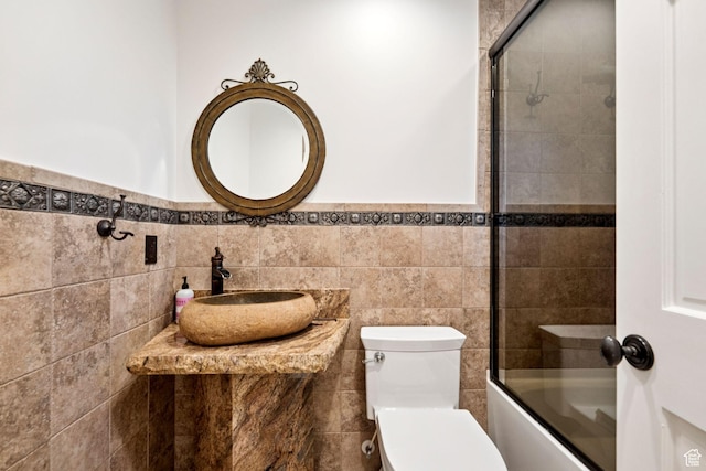 4307 Churchill Dr N Unit 97, Provo, UT 84604 - bathroom featuring tile walls, enclosed tub / shower combo, and a wainscoted wall