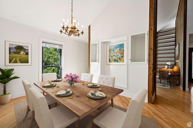 4307 Churchill Dr N Unit 97, Provo, UT 84604 - dining area with a chandelier, light wood-style flooring, high vaulted ceiling, and stairs