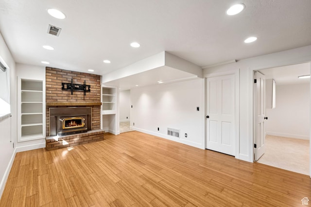 4307 Churchill Dr N Unit 97, Provo, UT 84604 - unfurnished living room featuring recessed lighting, built in shelves, light wood-style flooring, and a fireplace