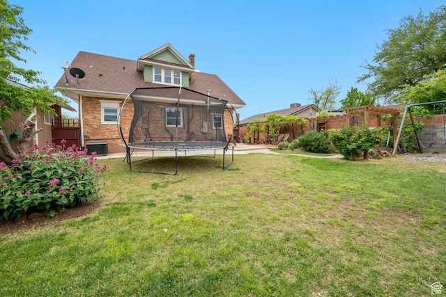 266 W 200 S, Hurricane, UT 84737 - rear view of property featuring a trampoline, a chimney, a fenced backyard, and brick siding