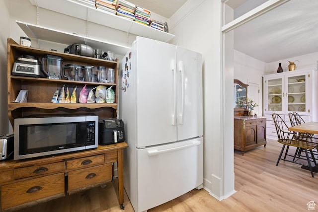 266 W 200 S, Hurricane, UT 84737 - kitchen with freestanding refrigerator, stainless steel microwave, and light wood finished floors
