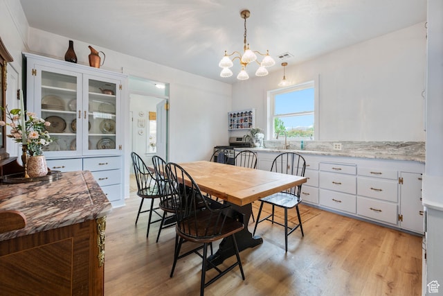 266 W 200 S, Hurricane, UT 84737 - dining area featuring light wood-type flooring and a chandelier