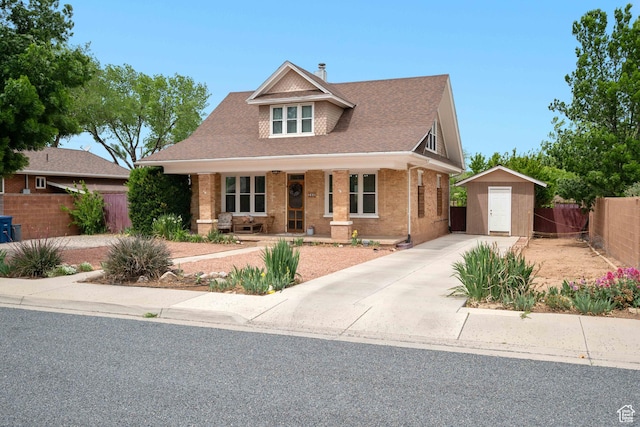 266 W 200 S, Hurricane, UT 84737 - bungalow-style home featuring a shed, covered porch, brick siding, roof with shingles, and driveway