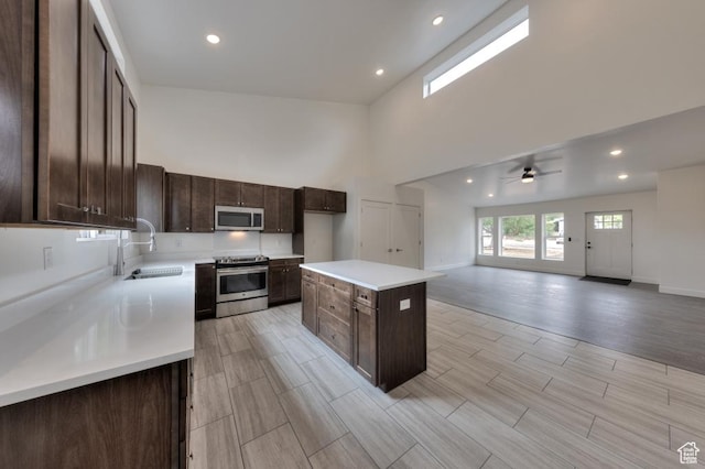 1191 Wagner Ave, Moab, UT 84532 - kitchen with stainless steel appliances, a towering ceiling, a ceiling fan, light countertops, and dark brown cabinets