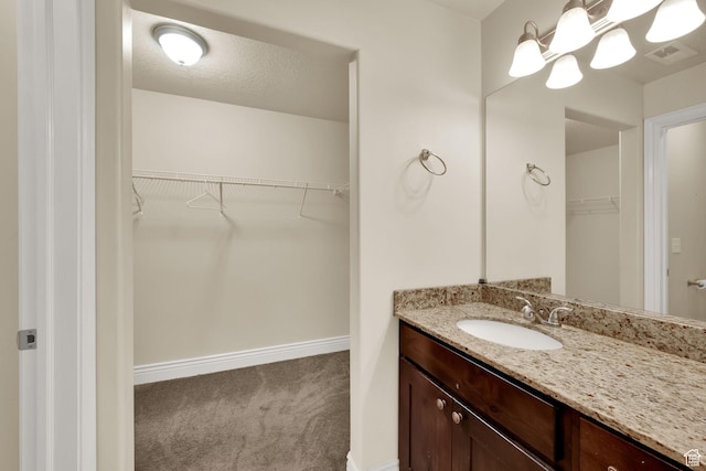 8264 S Resaca Dr Unit K9, Sandy, UT 84070 - bathroom with vanity and a walk in closet
