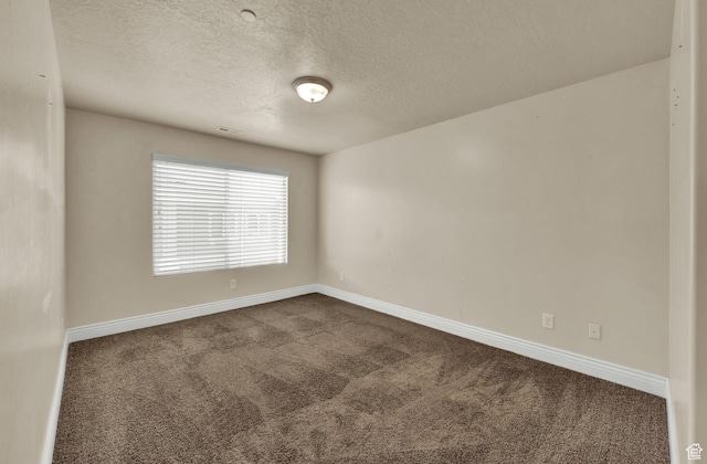 8264 S Resaca Dr Unit K9, Sandy, UT 84070 - spare room featuring dark carpet and a textured ceiling