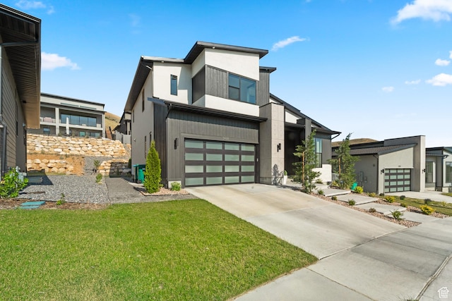 5488 N Valley Rd E, Lehi, UT 84043 - contemporary house featuring concrete driveway, a garage, a front yard, and stucco siding