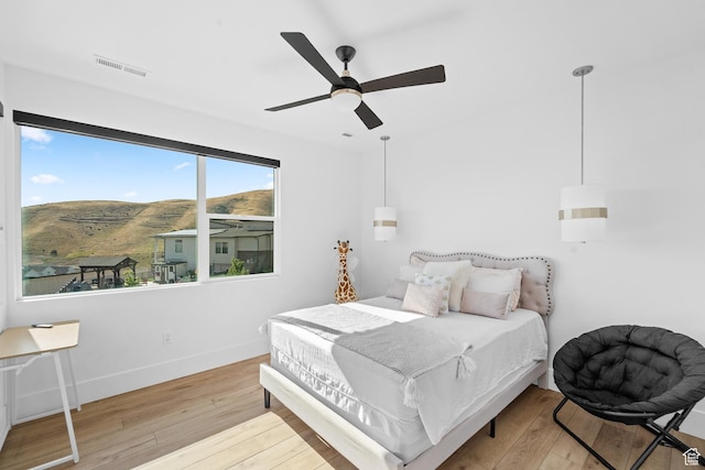 5488 N Valley Rd E, Lehi, UT 84043 - bedroom featuring hardwood / wood-style flooring, a mountain view, and ceiling fan