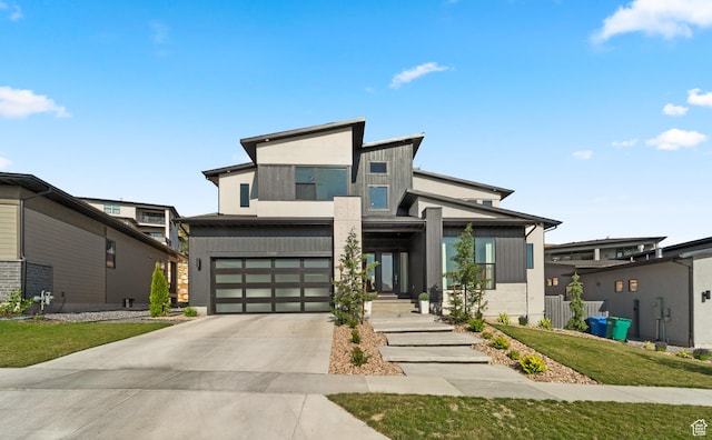 5488 N Valley Rd E, Lehi, UT 84043 - contemporary home featuring concrete driveway, a garage, and a front lawn