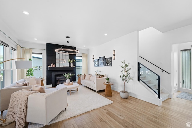 5488 N Valley Rd E, Lehi, UT 84043 - living area with light wood-style floors, a fireplace, recessed lighting, and stairs