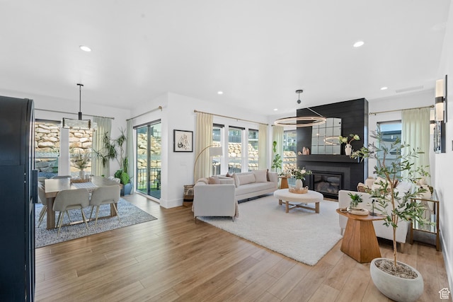 5488 N Valley Rd E, Lehi, UT 84043 - living area with light wood-style floors, recessed lighting, and a large fireplace