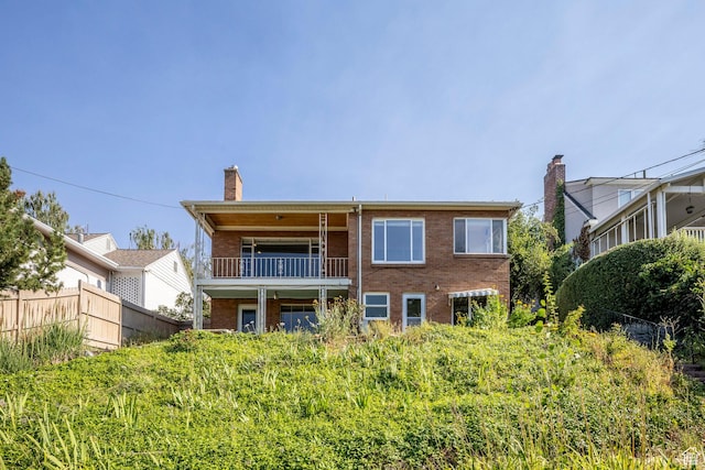 420 E 12th Ave, Salt Lake City, UT 84103 - back of house with a balcony, brick siding, and a chimney